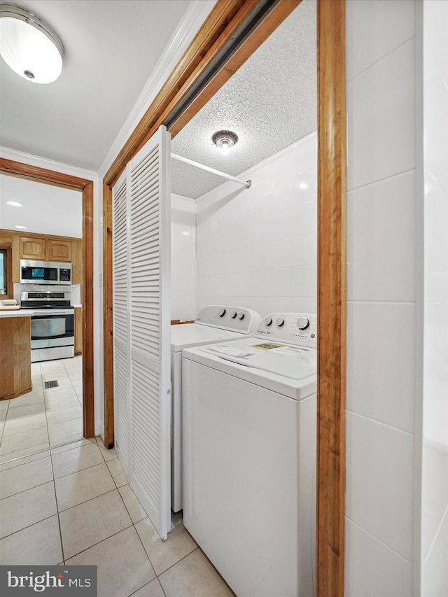 258 Merrimack, Falling Waters, WV 25419 - laundry area featuring washing machine and clothes dryer and light tile patterned floors