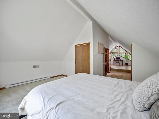 258 Merrimack, Falling Waters, WV 25419 - carpeted bedroom with a baseboard heating unit and vaulted ceiling