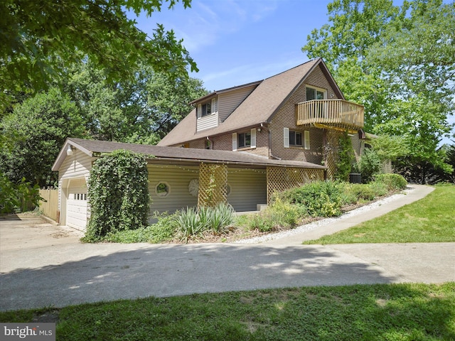 258 Merrimack, Falling Waters, WV 25419 - view of side of property with a balcony, a garage, brick siding, and concrete driveway