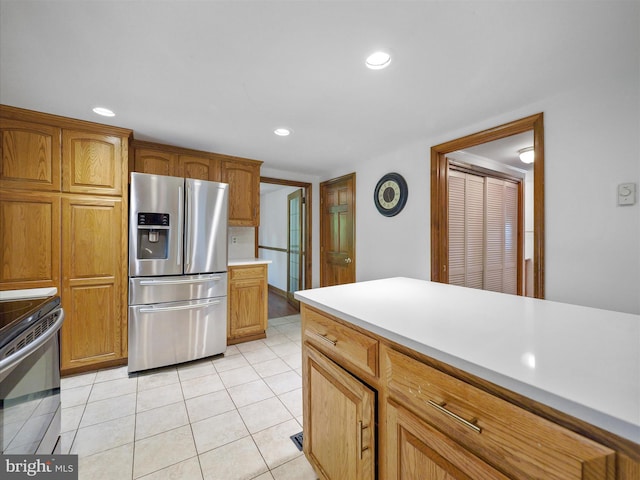 258 Merrimack, Falling Waters, WV 25419 - kitchen with appliances with stainless steel finishes, light countertops, light tile patterned floors, brown cabinets, and recessed lighting