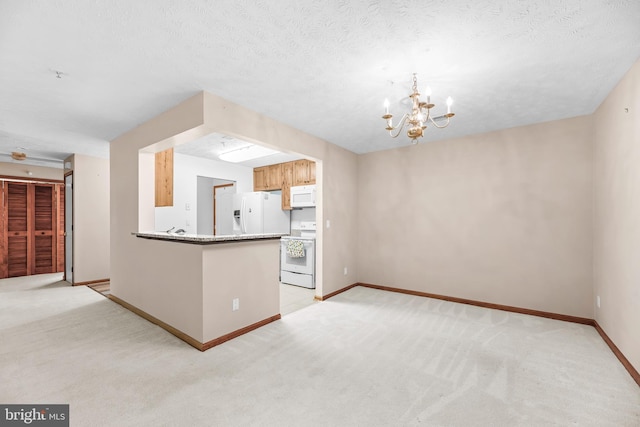 23140 Cobblestone Ln Unit 109, California, MD 20619 - kitchen featuring white appliances, light carpet, a chandelier, and a peninsula