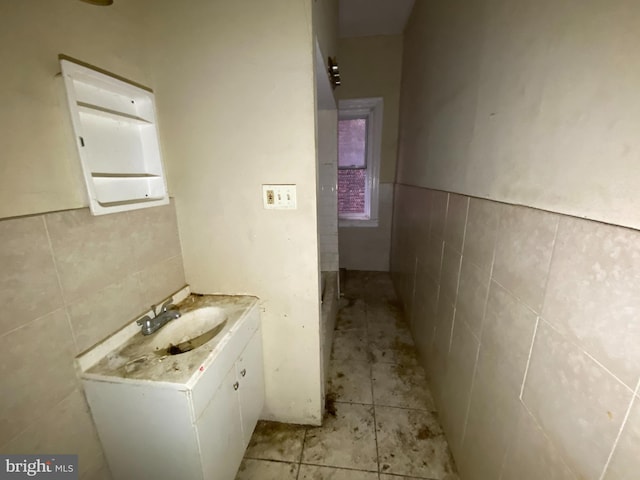 2110 N Charles St N, Baltimore, MD 21218 - bathroom featuring tile walls, vanity, a wainscoted wall, and tile patterned floors
