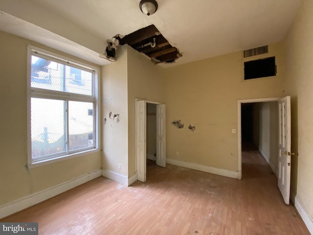 2110 N Charles St N, Baltimore, MD 21218 - unfurnished bedroom with light wood-style floors and baseboards