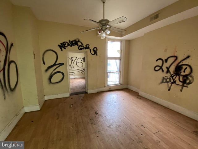 2110 N Charles St N, Baltimore, MD 21218 - empty room with wood finished floors and ceiling fan