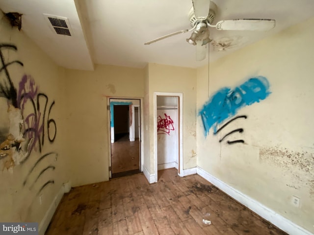 2110 N Charles St N, Baltimore, MD 21218 - unfurnished bedroom with wood-type flooring and a ceiling fan