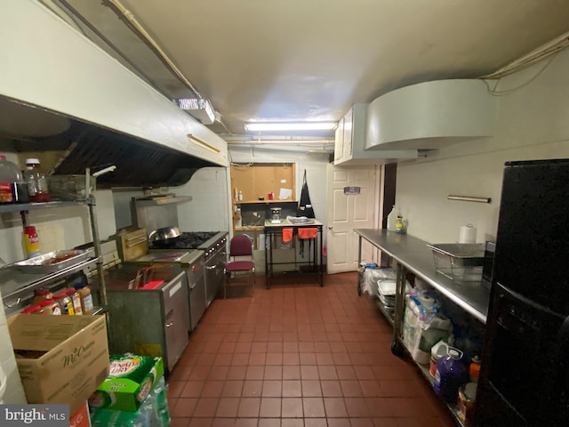 2110 N Charles St N, Baltimore, MD 21218 - kitchen featuring freestanding refrigerator, dark tile patterned flooring, and dark countertops