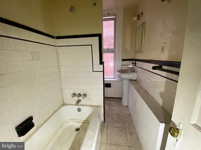 2110 N Charles St N, Baltimore, MD 21218 - full bathroom featuring a bath, tile walls, tile patterned flooring, healthy amount of natural light, and wainscoting
