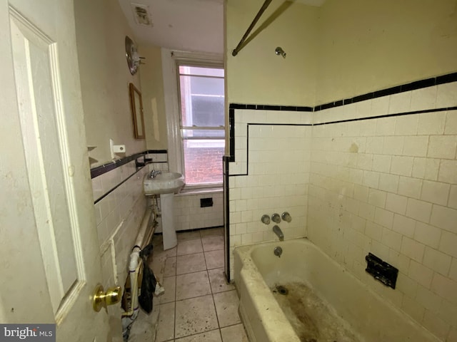 2110 N Charles St N, Baltimore, MD 21218 - bathroom featuring tile walls, a bathtub, tile patterned floors, and a wainscoted wall