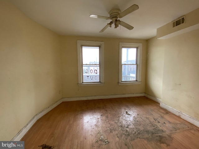 2110 N Charles St N, Baltimore, MD 21218 - unfurnished room with light wood finished floors and a ceiling fan