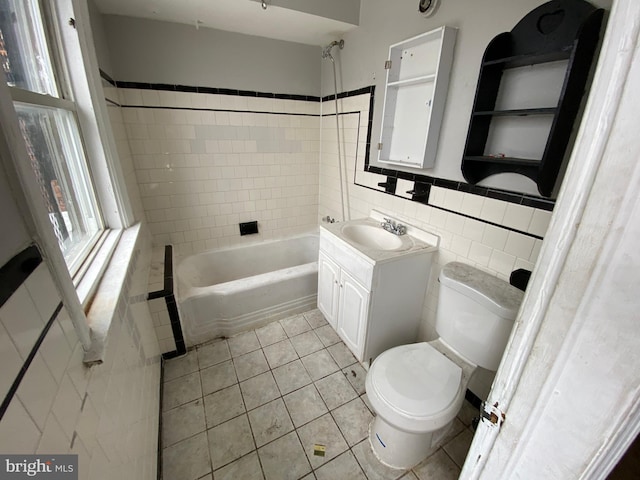 2110 N Charles St N, Baltimore, MD 21218 - bathroom featuring vanity, tile walls, a bathtub, and tile patterned floors