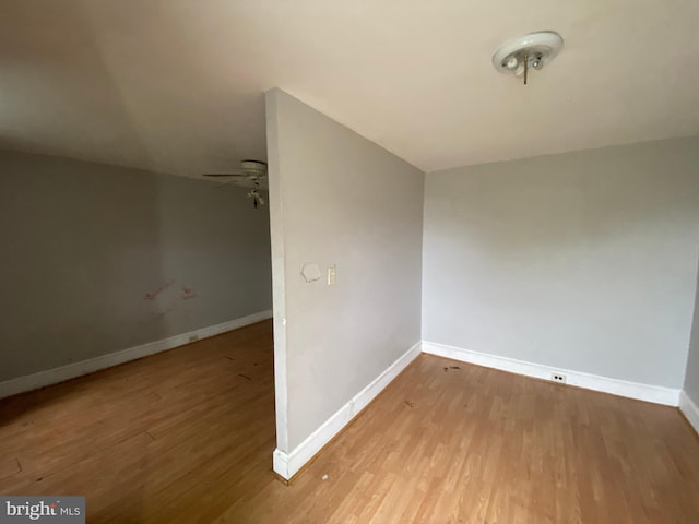 2110 N Charles St N, Baltimore, MD 21218 - spare room featuring wood finished floors and a ceiling fan