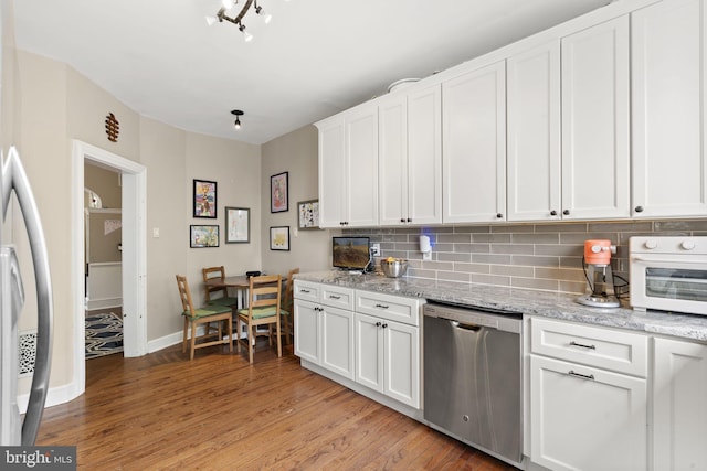 33 Waverly Rd, Wyncote, PA 19095 - kitchen with stainless steel dishwasher, decorative backsplash, light wood-type flooring, and white cabinets