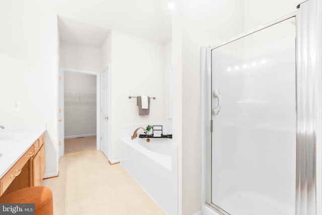 4049 Chatham Dr, King George, VA 22485 - bathroom featuring a stall shower, a bath, vanity, tile patterned floors, and a walk in closet