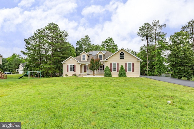 4049 Chatham Dr, King George, VA 22485 - traditional home featuring a playground, solar panels, and a front yard