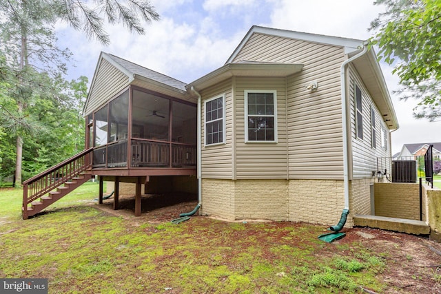 4049 Chatham Dr, King George, VA 22485 - view of side of home with a sunroom, stairway, a ceiling fan, and a lawn
