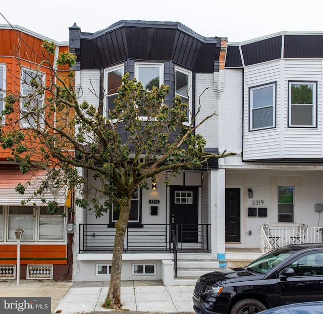 3321 N 11th St, Philadelphia, PA 19140 - view of property with a porch and brick siding