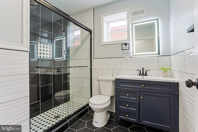3321 N 11th St, Philadelphia, PA 19140 - full bath with tile walls, a shower stall, vanity, and tile patterned floors