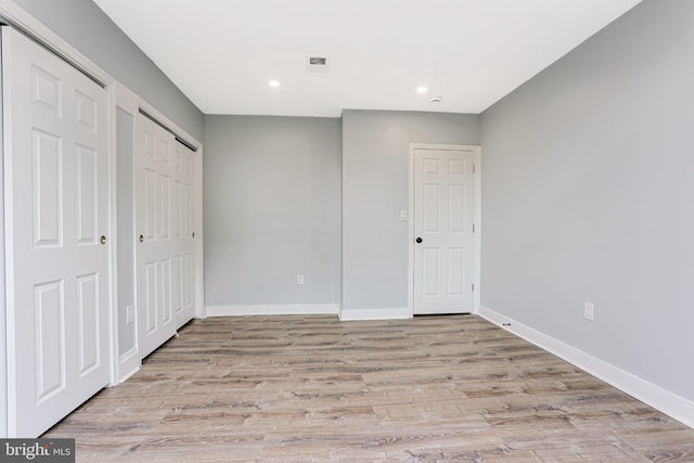 3321 N 11th St, Philadelphia, PA 19140 - unfurnished bedroom with light wood-type flooring, recessed lighting, and two closets