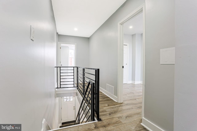 3321 N 11th St, Philadelphia, PA 19140 - corridor with an upstairs landing, wood finished floors, and recessed lighting