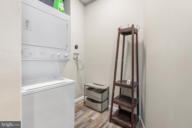 1001 S Carey St, Baltimore, MD 21223 - laundry area featuring stacked washer / dryer and light wood-type flooring