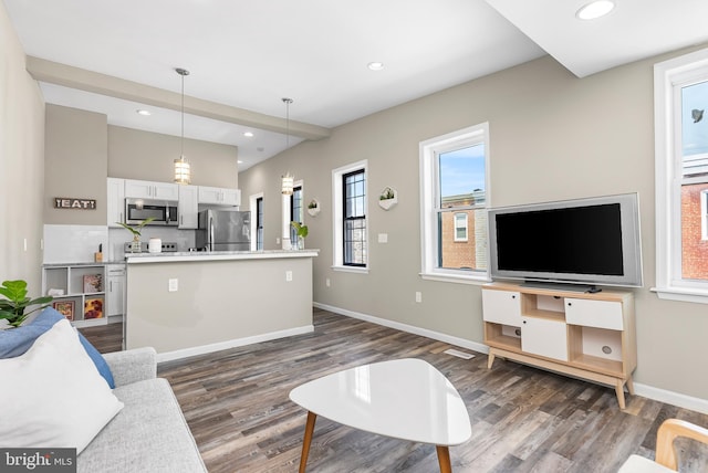 1001 S Carey St, Baltimore, MD 21223 - living area featuring dark wood-style flooring, plenty of natural light, and recessed lighting