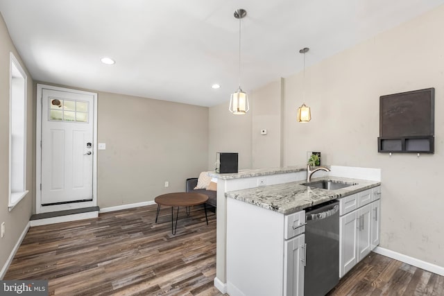 1001 S Carey St, Baltimore, MD 21223 - kitchen featuring stainless steel dishwasher, dark wood-style floors, a peninsula, light stone countertops, and white cabinetry