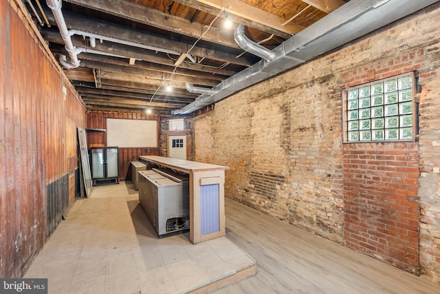 1001 S Carey St, Baltimore, MD 21223 - basement with brick wall and light flooring
