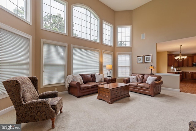 13 Buckwalter Cir, Royersford, PA 19468 - living area with a towering ceiling, a chandelier, healthy amount of natural light, and light carpet