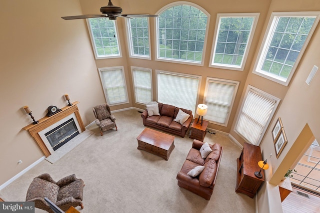 13 Buckwalter Cir, Royersford, PA 19468 - living room featuring a high ceiling, a glass covered fireplace, carpet flooring, and a ceiling fan