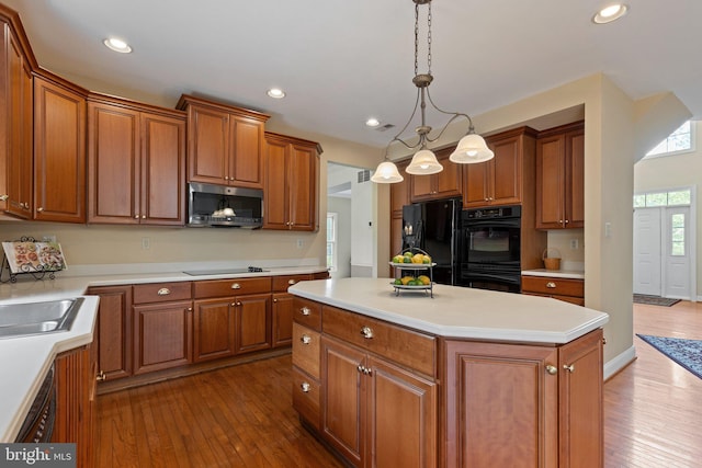 13 Buckwalter Cir, Royersford, PA 19468 - kitchen featuring black appliances, dark wood-style floors, a center island, brown cabinets, and recessed lighting