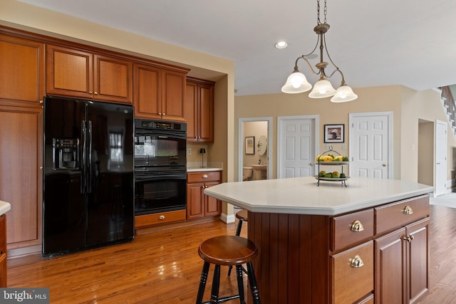 13 Buckwalter Cir, Royersford, PA 19468 - kitchen featuring black appliances, light wood-type flooring, brown cabinetry, light countertops, and recessed lighting