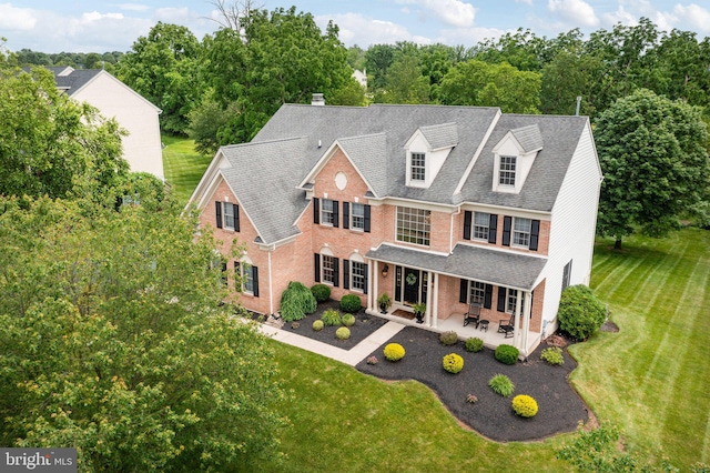 13 Buckwalter Cir, Royersford, PA 19468 - view of front of house with brick siding, a patio, a front lawn, and a chimney