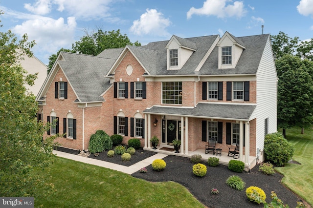 13 Buckwalter Cir, Royersford, PA 19468 - georgian-style home with brick siding, a front yard, and a shingled roof