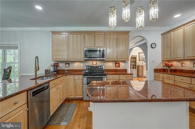 12020 Bennett Ct, Glen Allen, VA 23059 - kitchen featuring appliances with stainless steel finishes, light brown cabinetry, arched walkways, crown molding, and dark stone countertops