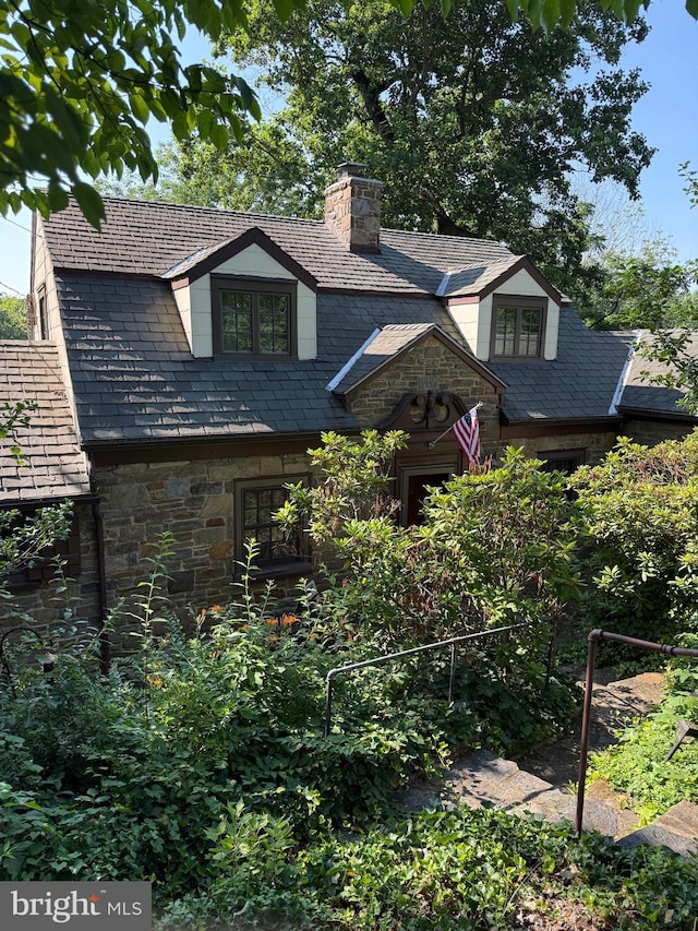 306 Euclid Ave, Wilmington, DE 19809 - tudor-style house with a high end roof, a chimney, and stone siding
