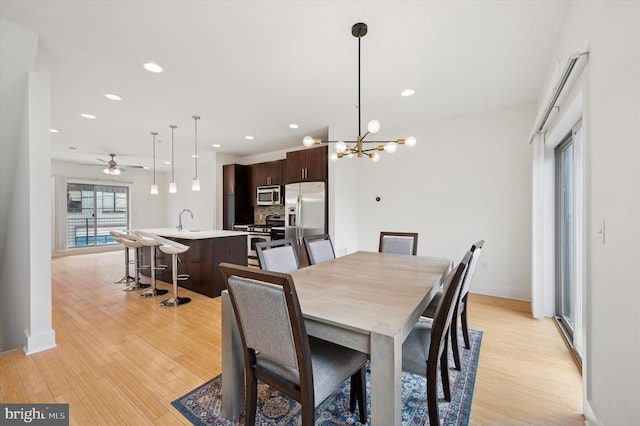 914 N Front St, Philadelphia, PA 19123 - dining space featuring light wood finished floors, a ceiling fan, a chandelier, and recessed lighting