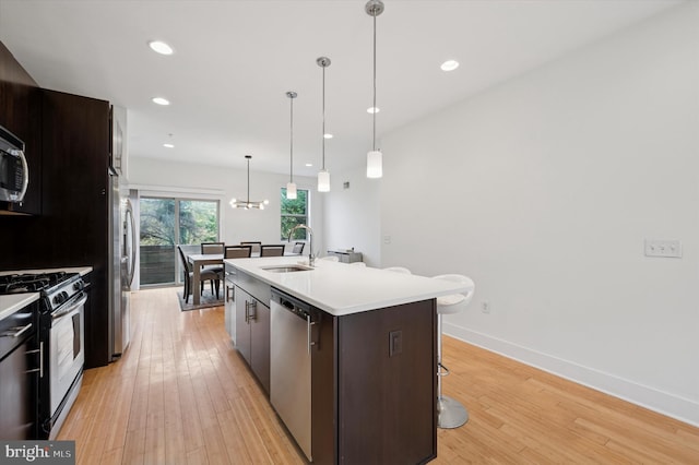 914 N Front St, Philadelphia, PA 19123 - kitchen with stainless steel appliances, light wood finished floors, an island with sink, light countertops, and recessed lighting