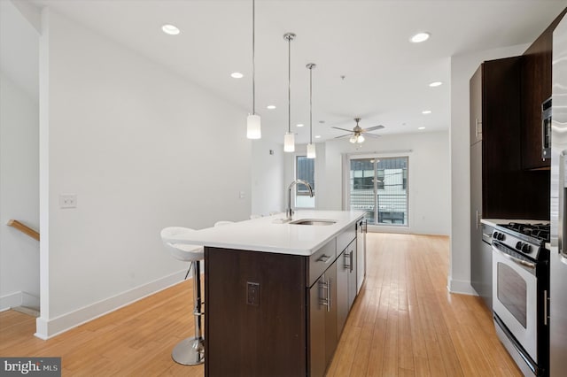 914 N Front St, Philadelphia, PA 19123 - kitchen with stainless steel appliances, a ceiling fan, dark brown cabinets, light countertops, and an island with sink