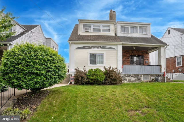 1128 Wilson Dr, Havertown, PA 19083 - view of front facade featuring a porch, a chimney, a front lawn, and a shingled roof