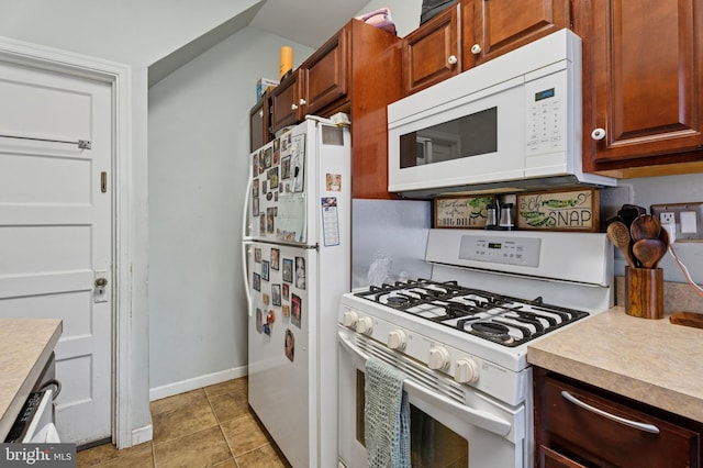 1128 Wilson Dr, Havertown, PA 19083 - kitchen with white appliances, light countertops, and light tile patterned floors