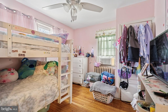 1128 Wilson Dr, Havertown, PA 19083 - bedroom with wood finished floors, radiator heating unit, and ceiling fan