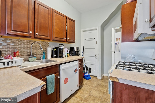 1128 Wilson Dr, Havertown, PA 19083 - kitchen with white dishwasher, stove, decorative backsplash, and light countertops