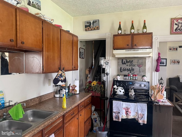 215 E Offutt St, Cumberland, MD 21502 - kitchen featuring under cabinet range hood, black range with electric stovetop, brown cabinets, a textured ceiling, and dark countertops