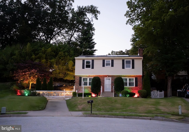 10 Kilkea Ct, Nottingham, MD 21236 - colonial home featuring roof mounted solar panels, brick siding, and a chimney