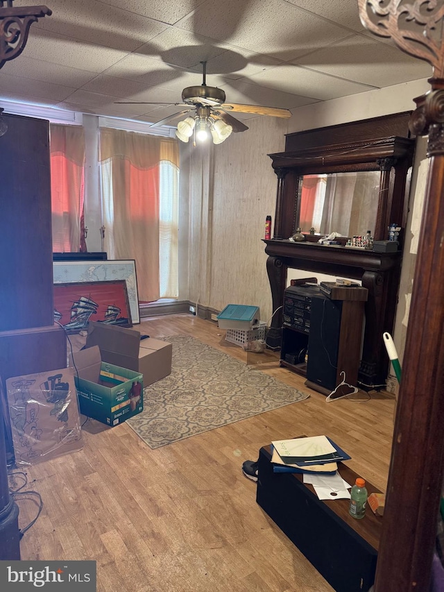 2008 W Lexington St, Baltimore, MD 21223 - living room with wood finished floors, ceiling fan, and a drop ceiling