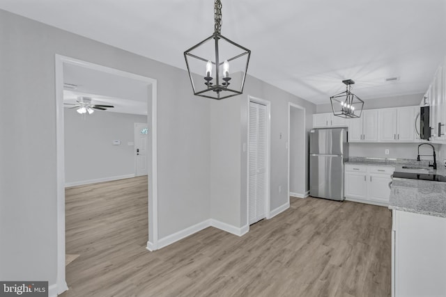 18721 Paprika Ct, Germantown, MD 20874 - kitchen with freestanding refrigerator, a chandelier, range, and white cabinetry