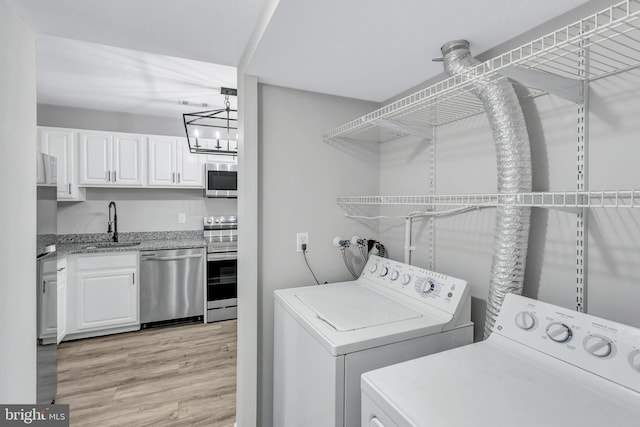 18721 Paprika Ct, Germantown, MD 20874 - laundry area featuring washer and dryer and light wood-type flooring