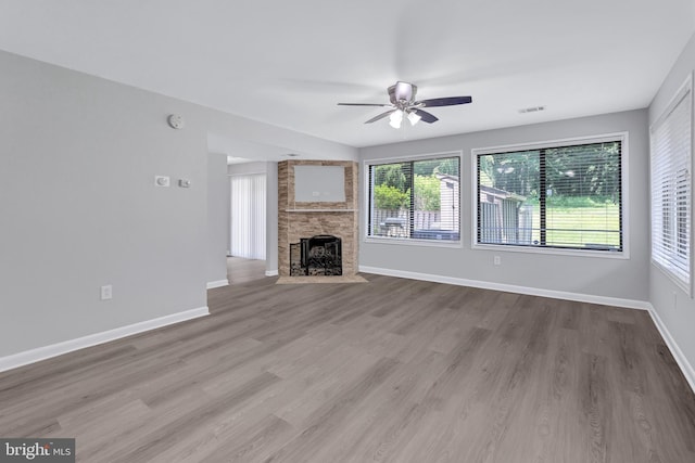 18721 Paprika Ct, Germantown, MD 20874 - unfurnished living room featuring ceiling fan, wood finished floors, and a fireplace