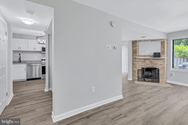 18721 Paprika Ct, Germantown, MD 20874 - unfurnished living room with a large fireplace and light wood-style flooring