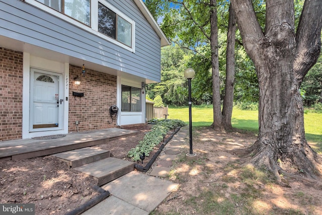 18721 Paprika Ct, Germantown, MD 20874 - view of exterior entry featuring brick siding and a lawn
